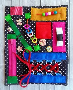 a piece of fabric with various items on it and some scissors hanging from the side