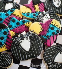 decorated cookies are arranged on a checkered table