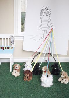 a group of stuffed animals sitting on top of a green carpeted floor next to a white chair