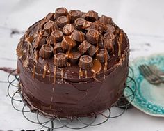 a chocolate cake sitting on top of a table next to a plate with a fork