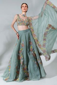 Dusty green can can attached lehenga featuring floral applique patterns highlighted with cutdana. Comes with padded blouse and dupatta.
Components: 3
Pattern: Embroidered
Type Of Work: Floral, Thread, Cutdana, Sequin
Neckline: Cut-out
Sleeve Type: Sleeveless
Fabric: Organza, Lining: Crepe
Color: Green
Other Details: 
Closure: Blouse and Lehenga: Side zip
Length:
Blouse: 13.5 Inches
Lehenga: 45 Inches
Model Height: 5 ft 9 Inches
Occasion: Sangeet,
Reception - Aza Fashions India Traditional Dress, Applique Work Lehenga, Carnival Outfit, Embroidered Lehenga Designs, Simple Lehenga, Aza Fashion Lehenga, Lehenga Pattern, Simple Lehenga Designs Classy, Lehengas Designs