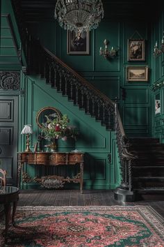 a room with green walls and wooden floors, a chandelier hanging from the ceiling