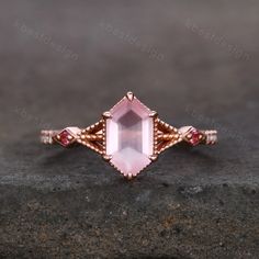 This is a vintage Long hexagon cut Rose Quartz and moissanite engagement ring in rose gold. A Modern Long Hexagon cut meets an intricate nature inspired design in this unique pink gemstone engagement ring.  Main Stone: 9x5mm hexagon cut Rose Quartz . Side stone: Pink tourmaline + Moissanite This ring is marked S925/G10K/G14K (According to the metal option) I accept custom making order.Please contact me if you need this service. For all the jewelries,there is a 14 days money back guarantee. You c Hexagon Gemstone Ring, Pink Gemstone Engagement Rings, Hexagon Engagement Ring, Pretty Engagement Rings, Vintage Rose Gold, Vintage Style Rings, Rose Quartz Ring, Ring Vintage, Pink Gemstones