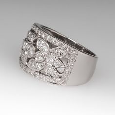 This lovely wide band diamond ring features 61 round brilliant diamonds that grade F-G in color and SI1-2 in clarity. They total 1.08 carats and are set in a floral motif. The ring is crafted of platinum and has a substantial feel. We offer complimentary resizing. Sizing up would be simple. Sizing down may be limited. Contact us with your size. Wide Band Diamond Ring With Brilliant Cut, Wedding Wide Band Diamond Ring With Brilliant Cut, Elegant Wide Band Diamond Ring, Wide Band Diamond Rings, Band Diamond Ring, Platinum Diamond Rings, Platinum Ring, Wide Bands, Brilliant Diamond