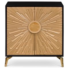 an art deco cabinet in gold and black with a sunburst design on the front