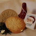 cookies, cookie stamp and christmas decoration on a bed