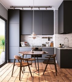 a kitchen with wooden floors and gray cabinets