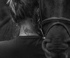 a woman with a horse's neck tattoo on her left side ribcage