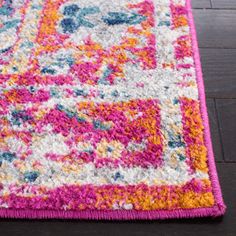 an area rug with multicolored designs on the floor in a living room or bedroom