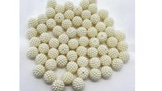 white beaded balls are arranged on a white surface