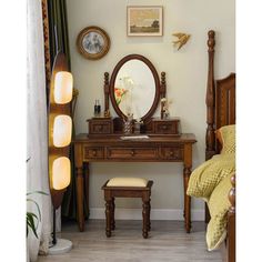 a bedroom with a vanity, mirror and stool