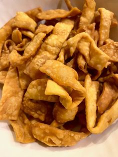 a pile of fried food sitting on top of a white plate