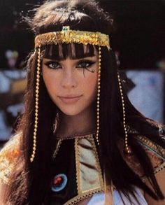 a close up of a person wearing a head piece with beads on it's head