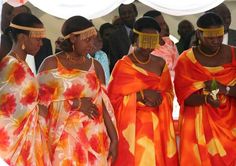 three women dressed in orange and yellow dresses