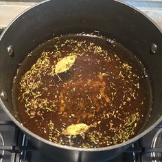 a pot filled with food sitting on top of a stove