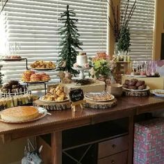 a table filled with lots of food and desserts