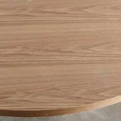 a close up view of the top of a round table with wood grained surface