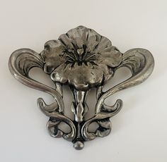 This beautiful art nouveau style craftsman pewter brooch features an intricate hand-designed flower. The brooch measures 2.5" wide x 2" long.  The back is marked "tine h pewter" with a secure locking pin that is in good working condition and a large bale to accommodate a large chain. Silver Design, Art Nouveau Style, Flower Brooch, Brooch Pin, Antique Silver, Beautiful Art, Brooches, Art Nouveau, Chain