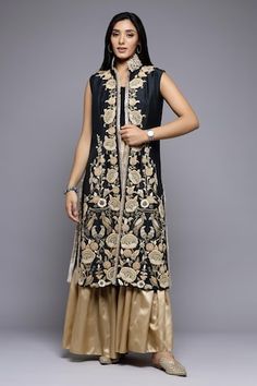 Black and gold long jacket style kurta with Mughal floral embroidery. Paired with a gharara. - Aza Fashions Floor-length Raw Silk Sharara With Gold Embroidery, Elegant Front Open Sharara For Eid, Designer Long Sharara With Intricate Embroidery, Designer Sharara With Gold Embroidery For Eid, Floor-length Sharara With Gold Embroidery For Eid, Bollywood Style Sharara With Gold Embroidery And Straight Kurta, Designer Sharara For Eid With Gold Embroidery, Designer Gold Embroidered Sharara For Eid, Gold Straight Kurta Palazzo Set For Reception