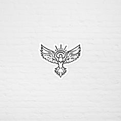 a white brick wall with a bird sticker on it