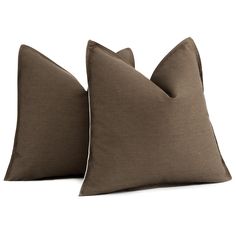 two brown pillows sitting next to each other