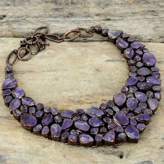 Note : Due to the natural formation of this gemstone. Slight variation in design and color are to be expected.  African Amethyst Rough Necklace Electroformed Copper Gemstone Necklace Adjustable Chain Necklace Copper Jewelry Handmade Necklace For Gift Handmade Electroformed Copper Necklace SKU : XN-60 Gemstone : African Amethyst Rough Metal Purity : Copper Necklace Length : 18 Inches With Adjustable Chain African amethyst relieves uneasiness, panic, annoyance, restlessness and increases firmness, inner energy and mental strength. African amethyst promotes spiritual awareness and wisdom. African amethyst promotes a higher state of consciousness. Amethyst also provides a wonderful and peaceful energy for meditation. Amethyst Jewel Pendant Necklaces, Amethyst Jewel Pendant Necklace, Amethyst Pendant Necklace With Jewels, Artisan Amethyst Jewelry With Stones, Unique Amethyst Necklaces, Round Amethyst Stone Necklace, Unique Round Amethyst Necklaces, Unique Round Amethyst Necklace, Copper Jewelry Handmade