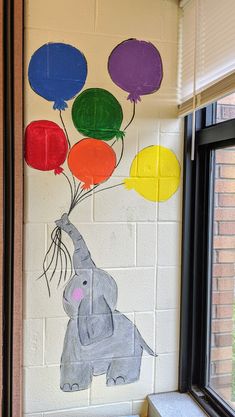 an elephant with balloons painted on the wall