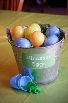 a bucket filled with eggs sitting on top of a table