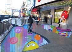 an art installation on the sidewalk in front of a mcdonald's and m & m