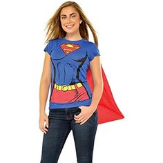 a woman wearing a superman t - shirt and jeans