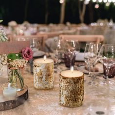 the table is set with flowers and candles