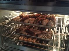 pine cones are cooking in an oven with the door open to allow them to cook