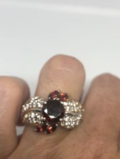 Vintage Red Bohemian Garnet White Sapphire 925 Sterling Silver Cocktail Statement Lovely Bohemian Garnet and white sapphire ring 925 Sterling silver Size 8 but can be re sized for you on request, my jeweler charges $10-$20 All rings are shipped in a nice gift box. Check out our over a THOUSAND great reviews Engraving is $4 per letter and is not always perfect depending on the piece. It can take a few days if the jeweler is busy. This is payable to Paypal Judithsltd@gmail.com Red Garnet Jewelry With Diamond Accents, Garnet Ring With Diamond Accents, Red Cluster Jewelry With Diamond Accents, Red Multi-stone Cluster Jewelry, Silver Cocktail, Garnet Gem, White Sapphire Ring, Black Sapphire, Red Band