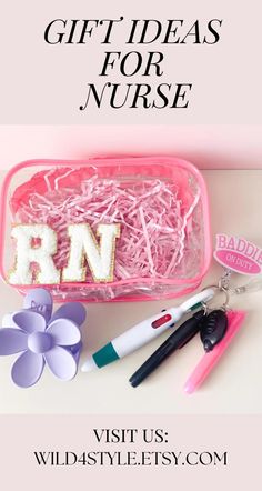 a pink box filled with letters and other items on top of a white countertop