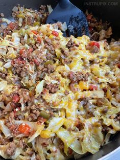 a skillet filled with pasta and meat