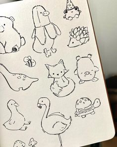 an open notebook with drawings of animals and birds on it