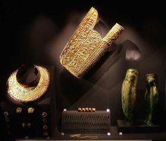 an assortment of ancient items on display in a museum