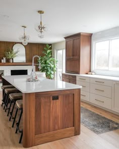 a large kitchen with wooden cabinets and white counter tops