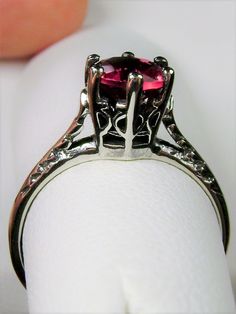 Simulated Red Ruby Ring Wedding #D22 This is a Victorian Era solitaire ring. This lovely sterling silver wedding solitaire has an approximately .5 carat simulated red ruby gemstone. This full cut flawless gemstone is 6mm (1/4") in diameter. The inside of the band is marked 925 for sterling silver. Notice the beautiful crown design of the silver filigree setting and the etched band. This is a lovely rendition of an Antique filigree ring. Classically fashioned, this ring is a vintage wedding style Red Ruby Ring, Antique Filigree, Victorian Wedding, Crown Design, Vintage Style Wedding, Filigree Ring, Ruby Gemstone, Engraved Items, Red Ruby