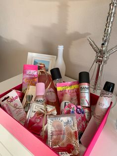 a pink box filled with lots of different types of beauty products and personal care items