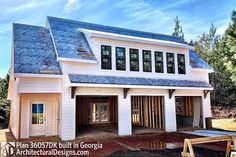 an image of a house being built in the middle of the day with blue shingles