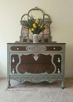 an old dresser with flowers in a vase on top