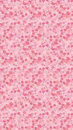 a pink and red flowered background with lots of small flowers on the bottom half of it