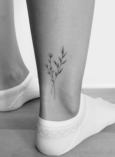 a black and white photo of a plant on the ankle