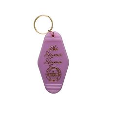 a pink plastic keychain with the words oh, santa fema on it