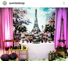 the eiffel tower is on display in front of pink curtains and other decorations