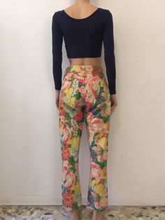 Multi color floral 1980s Kenzo Jeans! All over gorgeous floral print. Super cute summer style paired with a little crop top and beach hair. Fabric is a cotton denim. High waisted fit with five pockets and a tapered leg. Kenzo buttons up the fly - each copper button has the Kenzo logo. Kenzo face logo on back pocket. Label Kenzo Jeans, Miyuki, size US29, 100% cotton, please turn inside out and wash cool delicate and drip dry. Very good vintage condition - please note that the outside leg seam has 90s Style Wide Leg Summer Jeans, 90s Wide Leg Jeans For Summer, 90s Style Cotton Summer Pants, 90s High Waist Summer Pants, 90s High Waist Pants For Summer, High Waist 90s Style Pants For Summer, Multicolor Floral Print Pants For Spring, Spring Multicolor Floral Print Pants, High Waist 90s Jeans For Spring