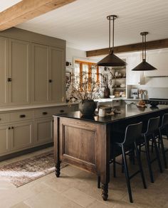 a large kitchen with an island in the middle