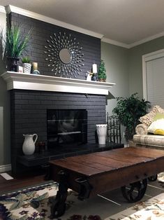 a living room with a couch, coffee table and fireplace