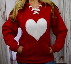 "Valentine's Day Shirt for Women. Sweatshirt Womens. Valentines Hoodie. Lace Up Sweatshirt. Red. Love shirt. Engagement. Bride. Heart. These are men's/unisex sizes. LADIES, because these are men's sizes, please order a size DOWN from your norm if you would like a more fitted look. I am 5'1, 115lbs with a 32D cup and I am wearing a small in the photos. Best. Hoodie. Ever. Simple. Classy. Versatile. American. Heavyweight. Super warm. Super soft. It will very quickly become your favorite sweatshirt Valentines Hoodie, Girls Valentines Outfit, Music Sweatshirts, Engagement Bride, Valentines Day Dresses, Valentine Dress, Dancers Outfit, Women Sweatshirt, Heart Sweatshirt